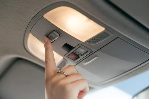 Driver controls the settings of his car with buttons Stock Photos