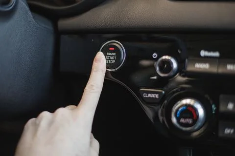 Driver controls the settings of his car with buttons Stock Photos