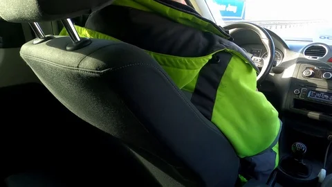 The driver, dressed in special clothes, goes along the highway. Stock Footage 127120609