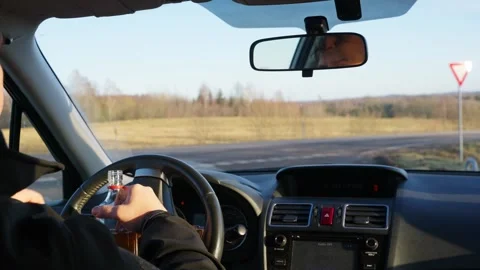Driver Drinking from Bottle While Driving, Dangerous Reckless Behavior Video stock 301635025