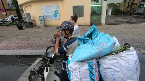 Driver is drinking coffee on a red traffic light in Ho Chi Minh, Vietnam Stock Footage 143957053
