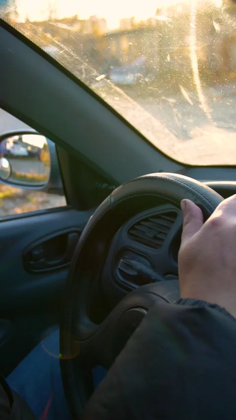 The driver drinks strong alcohol while driving - vertical video. Stock Footage 320357411