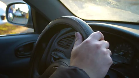 The driver drinks strong alcohol while driving. Drunk driving. Stock Footage 320382280