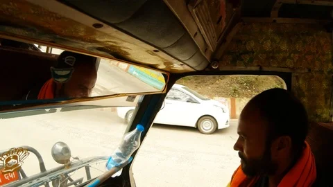 Driver drives autorickshaw reflection of face in rearview mirror Stock Footage 96322880