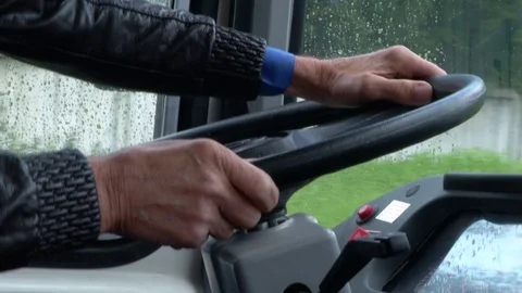 The driver drives a bus that rides around the city Stock Footage 115018264