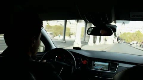 Driver drives a car in the central part of Paris Stock Footage 102384826