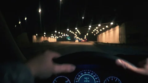 The driver drives a car through the night city, the beautiful streets Stock-Footage 81182607