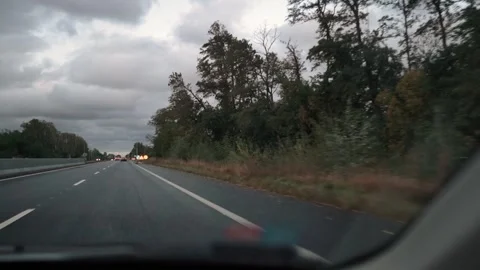 A driver is driving along a highway in the evening Vídeo Stock 331072944