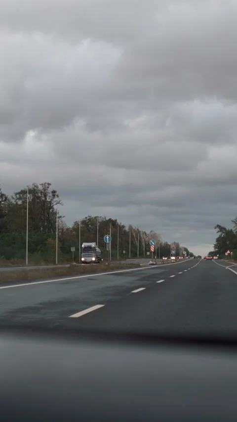 A driver is driving along a highway in the evening Vídeos de archivo 331072957
