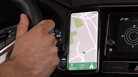 Driver Driving a Car With GPS Maps Open on a Smartphone Stock Footage 135103228