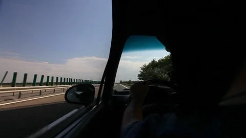 Driver Driving Car on Highway Back Lit Silhouette Backseat POV Video stock 87840920