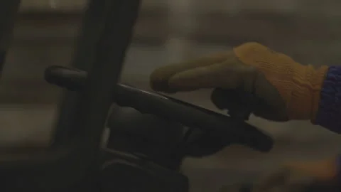 Driver is driving the forklift. The driver turns the steering wheel and levers Stock Footage 167853879