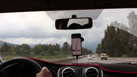 A driver driving on the highway with gps Stock Footage 129582260