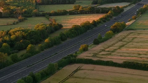Driver driving on motorway through peaceful countryside landscape. Aerial Stock Footage 340195560