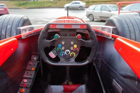 A driver driving a red Formula 1 sports car during a city race at high speed  Stock Photos