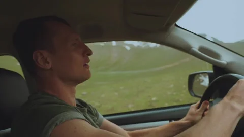 The driver is driving an SUV in the mountains Stock Footage 298841503