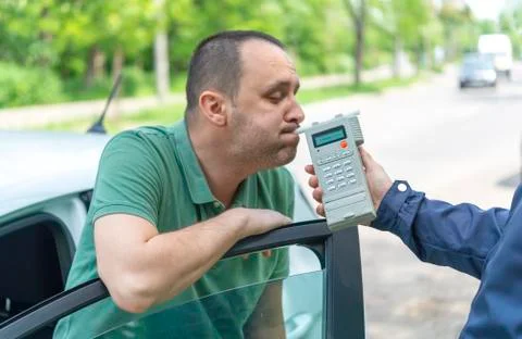 Driver due to being subject to test for alcohol content with use of breathaly Stock Photos