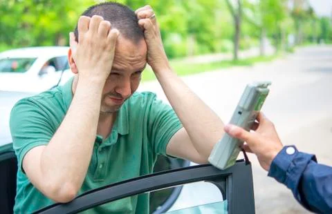 Driver due to being subject to test for alcohol content with use of breathaly Stock Photos