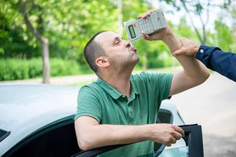Driver due to being subject to test for alcohol content with use of breathaly Stock Photos