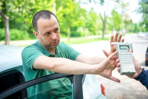 Driver due to being subject to test for alcohol content with use of breathaly Stock Photos