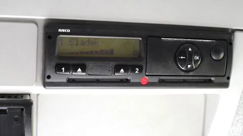 Driver ejects drivers card out of a digital tachograph and makes printout. Stock Footage 169160942