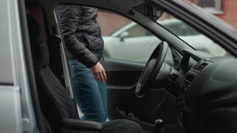 Driver Entering Car Seating and Gripping Steering Wheel on Commute Stock Footage 310515344
