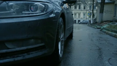 The driver exits the car. He closes the door and turns on the alarm. Stock Footage 80469665