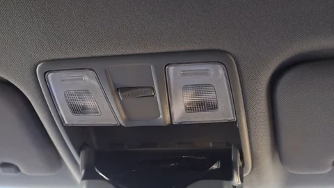 Driver exploring car salon. A little boy presses buttons in the car 스톡 동영상 82395527