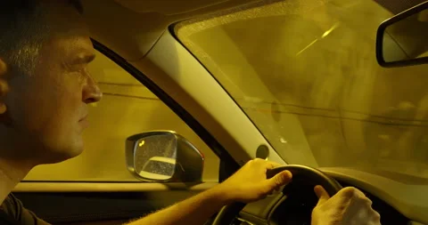 Driver face illuminated by tunnel lights Stock Footage 264928447
