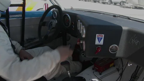 Driver flips switches in dash of race car, 4K. Stock Footage 146021887