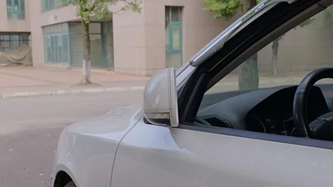 The driver folds in the left side mirror by hand. Stock Footage 329165872