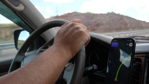 Driver following gps navigation on smartphone while driving car on highway Stock-Footage 313259299