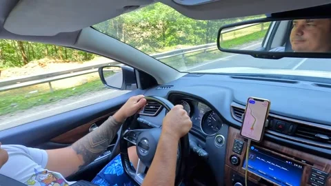 Driver follows mountain route, over-shoulder view inside a car Stock Footage 343773917