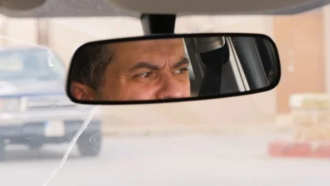 The driver in the front view mirror. Mindfulness on the road, the rules of the Stock Footage 101500528