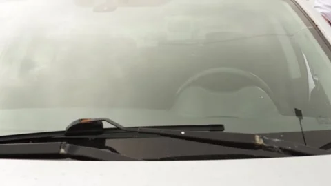 The driver gets into the car and fastens his seat belt, front view Stock Footage 252020081