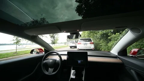 Driver gets into Tesla Model 3 and Pulls Out Stock Footage 91322758