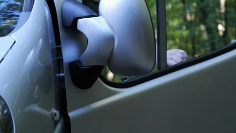 Driver Getting Into a Parked Car in the Forest Stockbeeldmateriaal 347041363