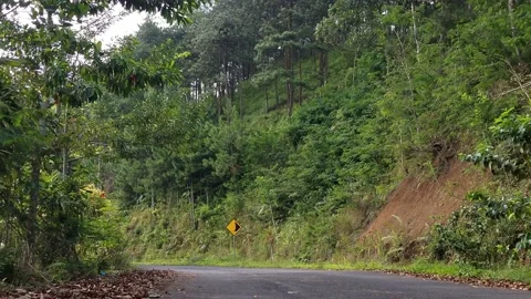 Driver goes through landslide warning sign Stock Footage 218231542