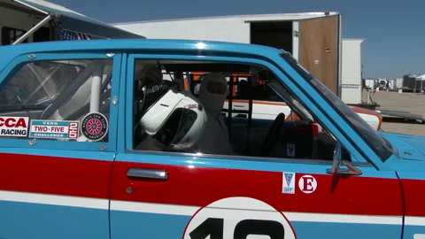 Driver grabs helmet to put on inside his car, 4K. Stock Footage 146022013