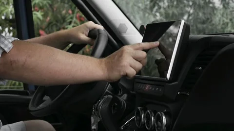 Driver hand entering data on multimedia touch screen Stock Footage 340077994