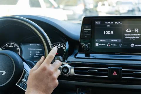 Driver hand on Kia steering wheel in modern car interior Stock Photos