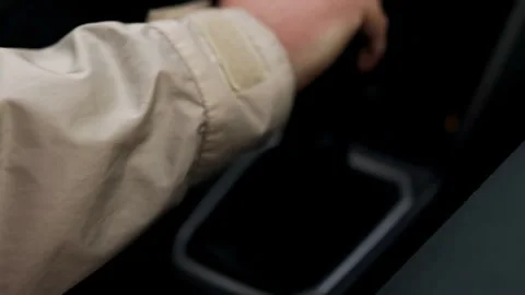 Driver hand on manual gear shift lever with climate control in background. Stock Footage 339581160