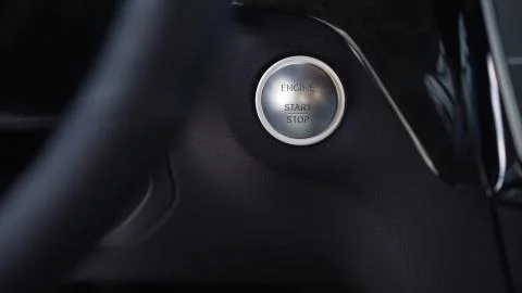 Driver hand pushes engine start stop button. Stock. Modern luxury crossover car Stock Photos