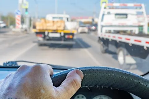 Driver hand on the steering wheel inside the car during a traffic jam Stock Photos
