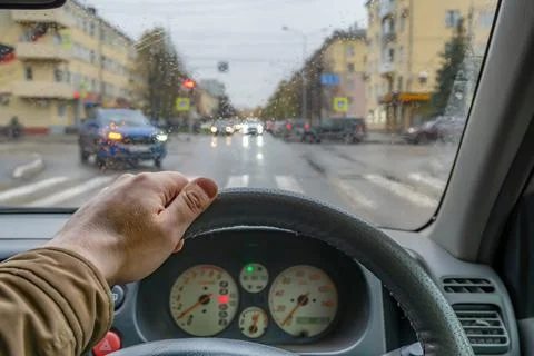 Driver hand on the steering wheel inside the car Stock Photos