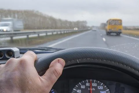 Driver hand is on the steering wheel inside the car Stock-Fotos