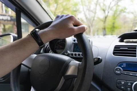 Driver Hand on Steering Wheel Inside Car Stock Photos