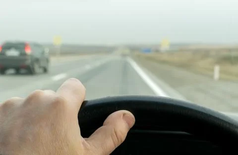 Driver hand on the steering wheel Stock Photos
