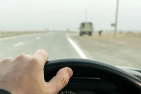 Driver hand on the steering wheel Stock Photos