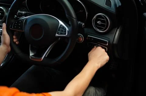 Driver Hand Turn On Switch Light. Stock-Fotos